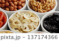 Nuts and dried fruits. Variety of different colored raw healthy food in bowls 137174366