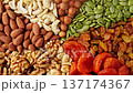Mixed dried fruit nuts on plate. Colorful assortment of nuts and dried fruits 137174367