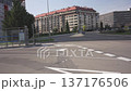 Spain, Madrid, barrio Sanchinarro, 02 25 2026, Cars driving on a city street with residential buildings and a bus stop on a sunny day 137176506