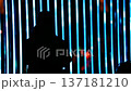 silhouette of a person under the beam of blue light 137181210