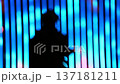 silhouette of a person under the beam of blue light 137181211