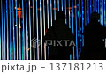 silhouette of a person under the beam of blue light 137181213