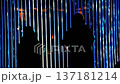 silhouette of a person under the beam of blue light 137181214