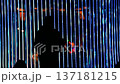 silhouette of a person under the beam of blue light 137181215