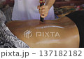 Traditional Thai Tok Sen massage therapy with wooden hammer for muscle relaxation and ancient Lanna healing. 137182182