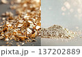 Shiny gold pieces laying on a surface while soft silver powder forms a small pile nearby. The focus is on the details of each material and their textures 137202889
