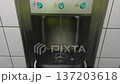 POV shot of a person using a modern automatic sensor faucet in a public restroom 137203618