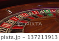 Intimate Portrayal Of Roulette Green Zero Pocket Alongside Moving Ball And Aged Wood Surface 137213913