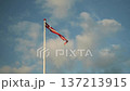 Cloudy Sky With Waving Flag. Gentle Evening Light Illuminates Waving Red Ribbon And Cloudy Backdrop 137213915