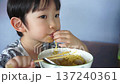 Cute Preschool Thai Boy in Iconic Elephant Print Shirt Eating Plain Yellow Egg Noodles. 137240361