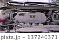 Car engine starting under open hood front view 137240371