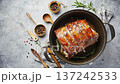 A roasted pork loin sits in a pot surrounded by herbs and seasoning. The camera shows browned surface and texture. The mood feels rustic and hearty. 137242533