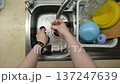 Washing Potatoes in Kitchen Sink 137247639