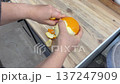The thick orange peel is peeled off, rustling, crackling, separating with hissing and soft pop 137247909