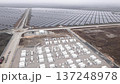 Unmanned Aerial Vehicle Shows Construction Site Near Expansive Solar Panel Installations Under 137248978