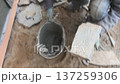 A builder faces the basement of a house with a wild stone. Flat for cladding, tabata on the construction site. 137259306