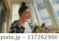 Casual woman gently applying drops before virtual meeting 137262900