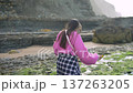 Tidepool discovery woman exploring coastal rock pools 137263205