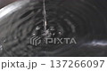 Water falling from a tap into a washtub 137266097