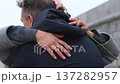 A loving couple hugs and twirls during a walk through the city during the cold season. 137282957