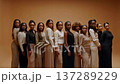 Confident Ladies In Stylish Neutral Outfits. Studio Women Display Unity And Fashionable Poise 137289229