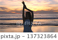 Woman in white dress posing on Santa Monica Beach at sunset California USA 137323864