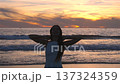 Woman in white dress on Santa Monica Beach at sunset California USA 137324359