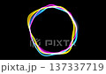 Colorful light patterns form circles in a dark area during an art event. People watch and enjoy the display of light and color in the night sky in the city. 137337719