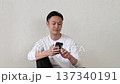 A Japanese man operating a smartphone in the living room 137340191
