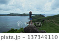 Female Explorer Pauses At Scenic Viewpoint Of Ocean Landscape 137349110