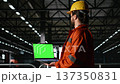 Isolated mockup on laptop with professional engineer in heavy industry warehouse facility, manufacturing process for production line. Industry hall operations with worksite worker. 137350831