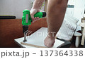 Caucasian man drilling hole for hinges in chipboard with Forstner bit and screwdriver closeup. Attaching furniture components and DIY furniture assembly and construction. 137364338