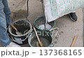 Craftsman mixing concrete with an electric mixer Mortar preparation work at a construction site 137368165