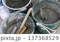Craftsman mixing concrete with an electric mixer Mortar preparation work at a construction site 137368529