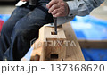 A video of a carpenter using a chisel to make a mortise hole in wood 137368620