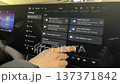 A driver uses a touchscreen in a modern car. 137371842