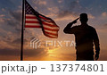 Soldier Saluting Waving USA Flag Sunset Camera Pull Back 137374801