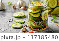 Jar of Pickled Cucumbers with Chili and Garlic on Concrete Background 137385480