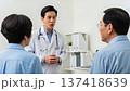 Medical - An Asian doctor explains treatment options to a patient and their caregiver in a modern examination room. 137418639