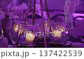 Intimate Dining Ambiance Created By Luminous Votive Candles In Crystalware Under Violet Lighting 137422539
