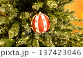 A painted Christmas tree ornament featuring snowflakes and reindeer. It evokes a Christmas fairy tale and creates a joyful mood. A perfect gift or home decoration. 137423046