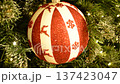 A painted Christmas tree ornament featuring snowflakes and reindeer. It evokes a Christmas fairy tale and creates a joyful mood. A perfect gift or home decoration. 137423047