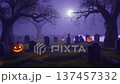 Enchanting Halloween graveyard scene with glowing pumpkins and misty atmosphere under moonlight 137457332