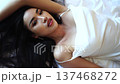 Beautiful Sexy Asian Woman Lying on Bed in White Dress, Slow Motion 137468272