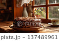 Chocolate cake sits on a plate next to a cup on a wooden table by a window with natural light in a cozy setting 137489961