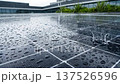 Rainwater Glistens on Solar Panels atop Modern Office Roof, Showcasing Efficiency and Sustainability of Green Energy Solutions in Contemporary Building Environments 137526596