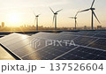 Green business solar panel office roof sunrise with wind turbine farm and clean city skyline for renewable energy and sustainable power concept 137526604