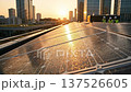 Green business solar panel roof office scene sunrise and sunset with dawn light over city skyline showing green energy installation engineers inspecting sustainable panels reflecting urban green city 137526605