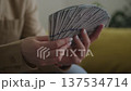 Woman Holding Fan of Dollar Cash 137534714