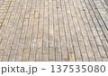 Texture of sunlit brick pavement from above, clean pedestrian sidewalk, urban background and paving stone surface. 137535080